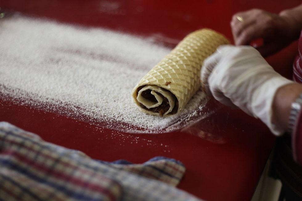 We forgot to do the step before in one of our waffle logs, but don't worry even if you forget to roll it into the icing sugar. You can roll, then run it through.
