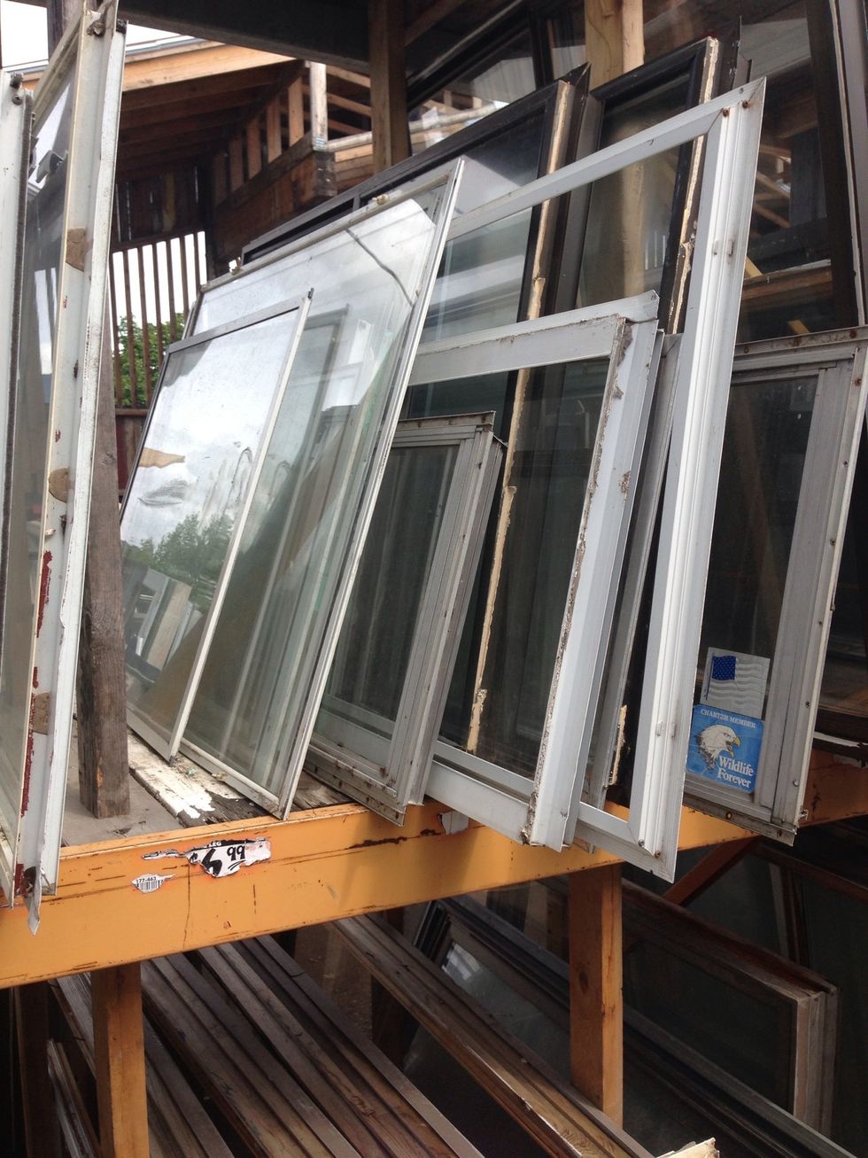 We found our plexiglass storm window at Home Resource, a local repository of building materials from deconstructed buildings. You can also use an old wooden frame glass window.