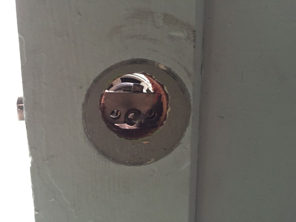 We'll be attaching the mounting plate and adapter where we just removed the deadbolt tail piece.