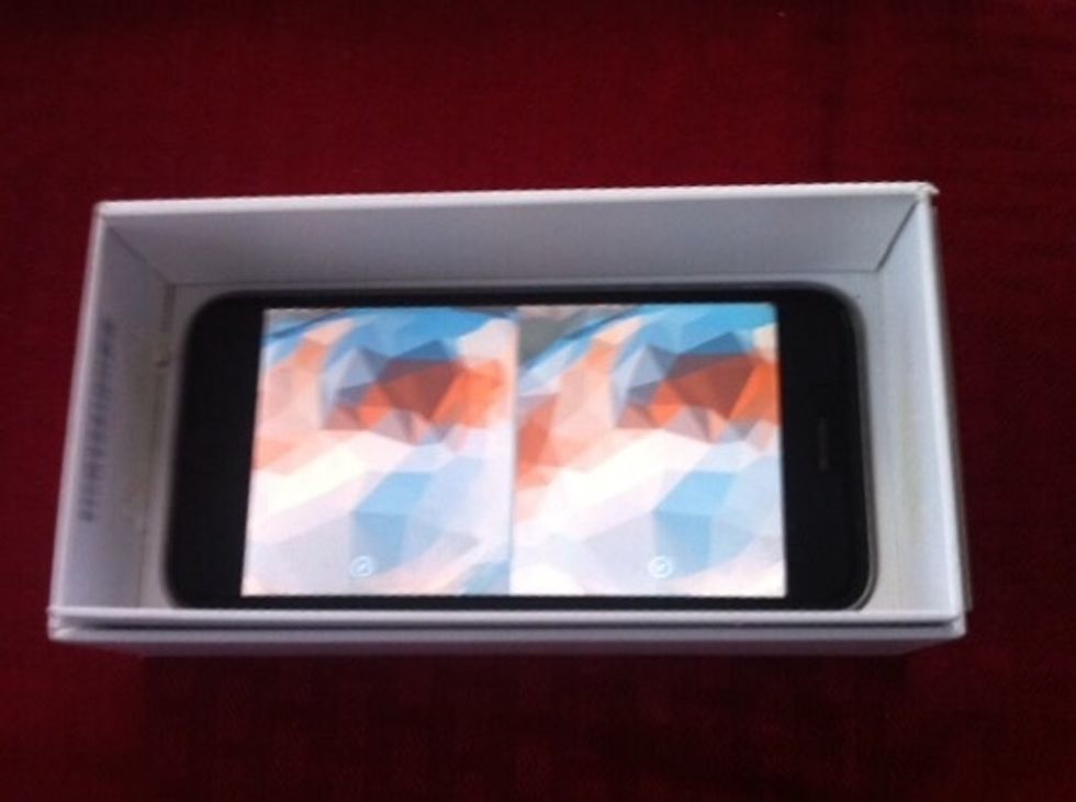 We'll work on the top of the box in a moment. But for now here's how you'll insert your iPhone into the bottom of the box. Open a VR app then put the iPhone in so its camera lines up with the hole.