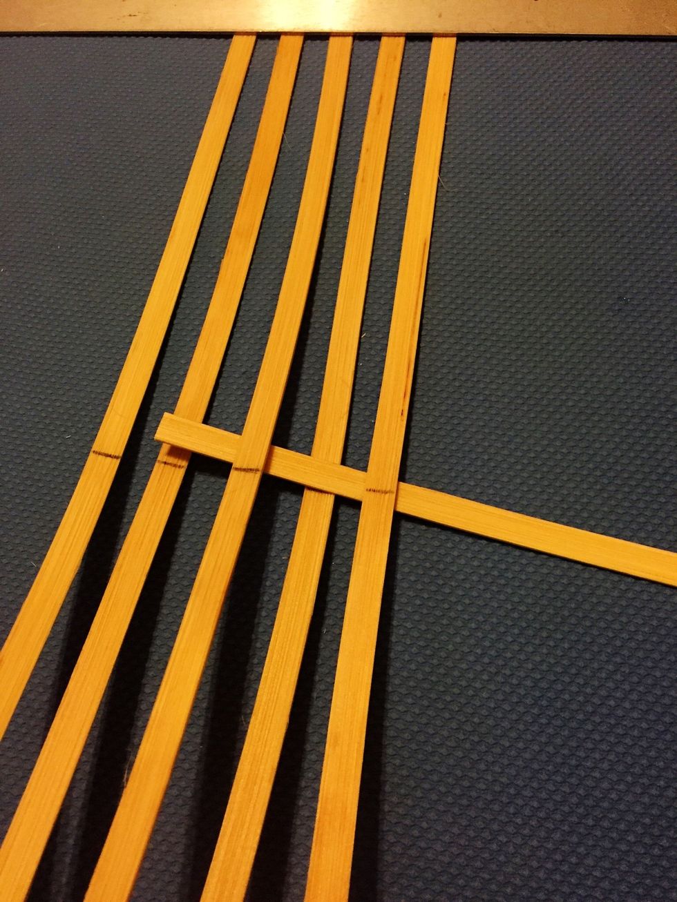We need to weave the other half of the spokes- the HORIZONTAL SPOKES-- in! One at a time, slide a spoke OVER one and UNDER the next. Follow this over, under pattern.