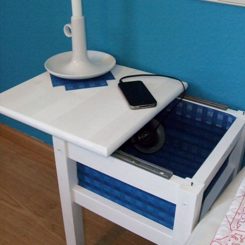 We needed a small bedside table for our guestroom. Using an Oddvar stool and Ingmaj curtain and two drawer slides, we created a bedside locker with a sliding top board.