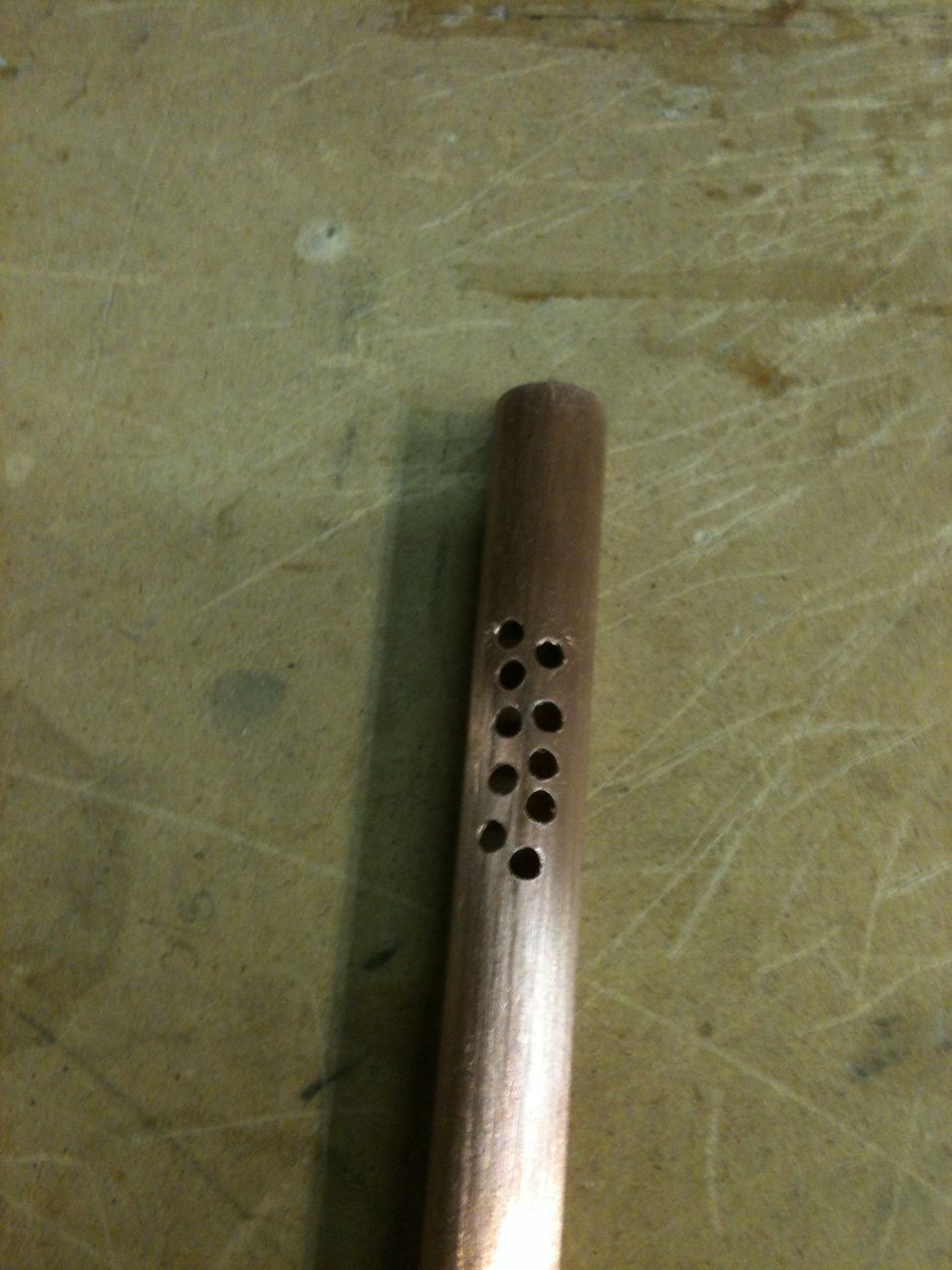 We now need to make a hole in the 1/2" pipe. I stared drilling out a lot of holes. I made the hole where it would be in the center of the canister.