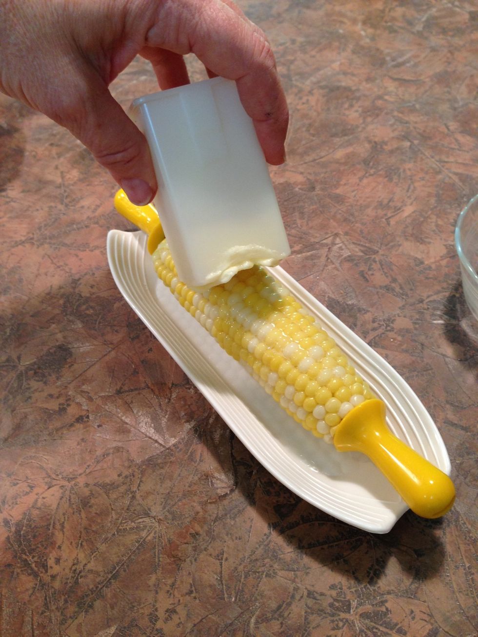 We picked up this handy corn butter-er. You press plastic piece to slide butter out.
