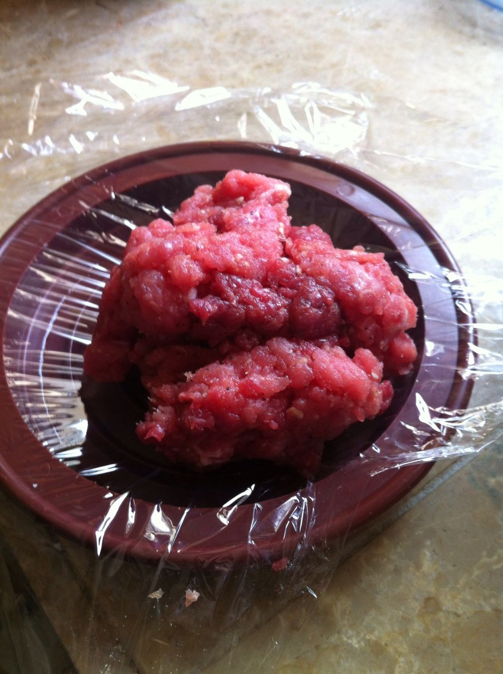 We placed the plastic wrap over the hamburger press.... Then add meat....