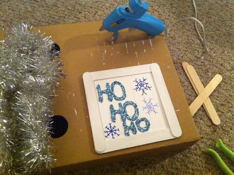 We're almost done! Time to add the garland to finish this off! Hot glue the garland to the outside of the frame.