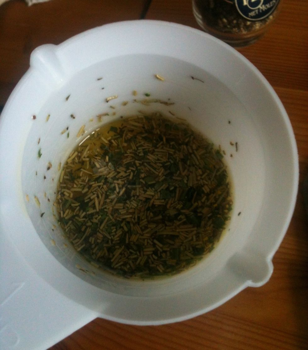 We start by adding olive oil and herbs into a small cup. As far as measurements go: just try whatever gets you going! No 'rules'!