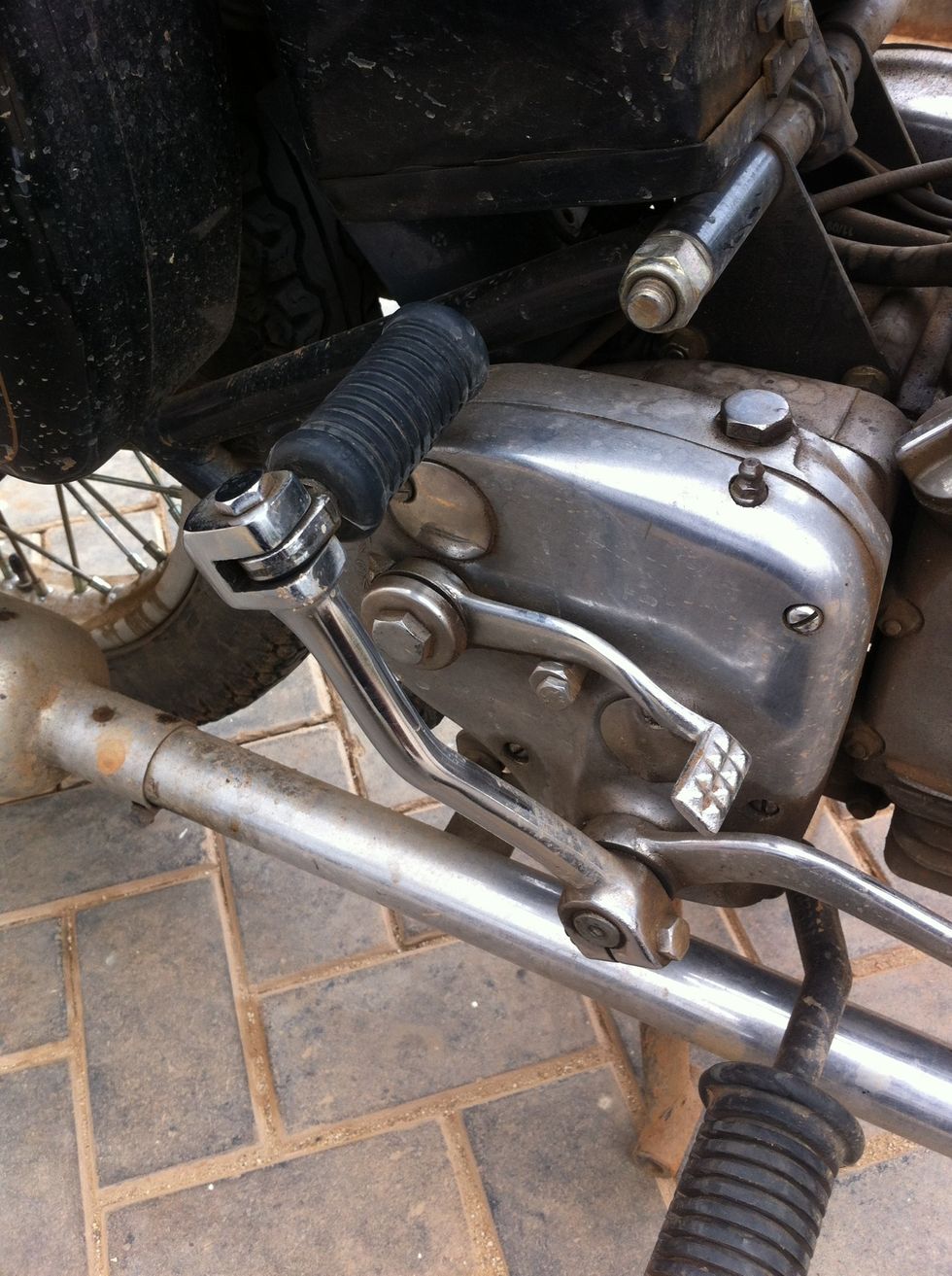 We start by moving the kicker out of the way for easy access to the clutch cable end.