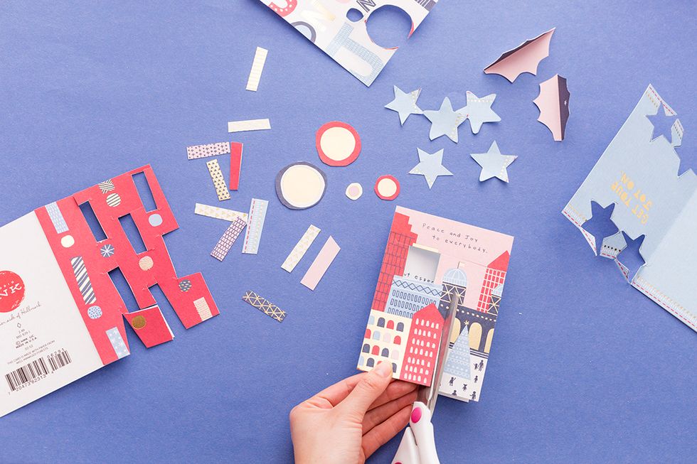 We started out by cutting out the illustrations in the cards, like the buildings, exclamation points and circles. Cut your own abstract shapes or cut out existing shapes in the cards.