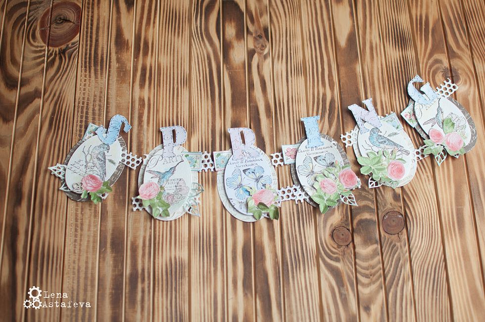 We stick the letters on the ovals.