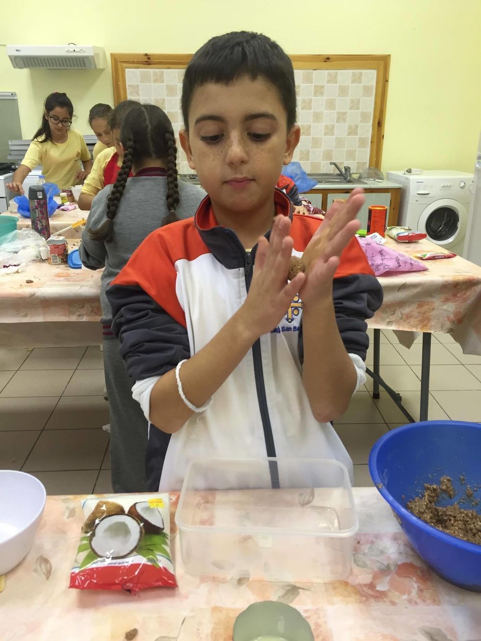 We then formed the mixture into small round balls by rolling the mixture in our hands.....