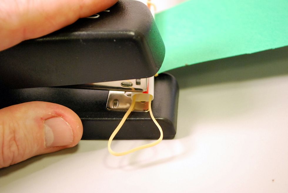 We try to staple in the center of the straw and not through the rubber band.