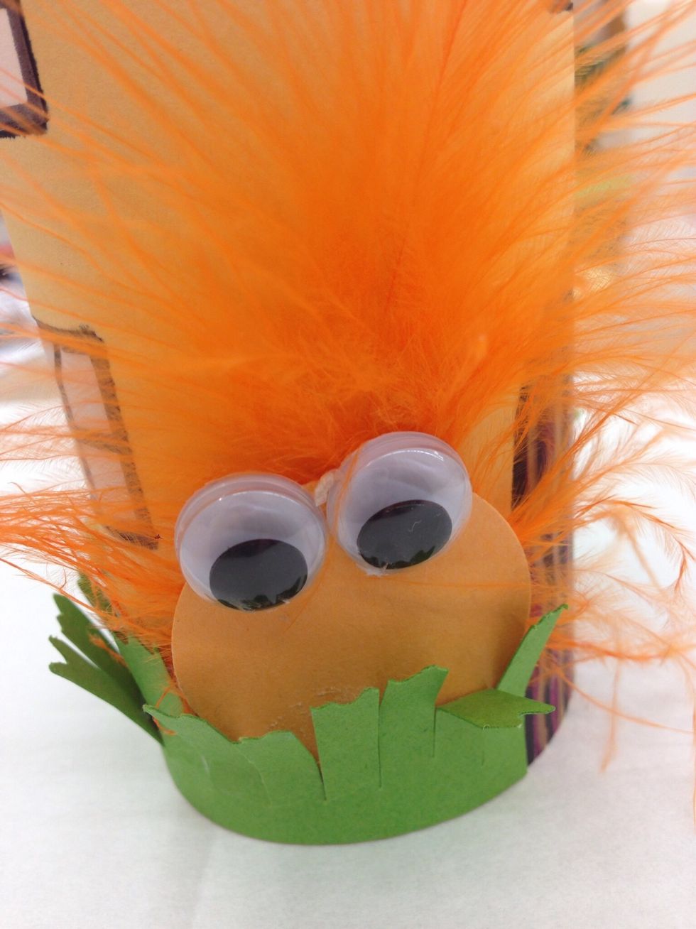 We used a feather, circle of paper and googly eyes to make a troll for this house.