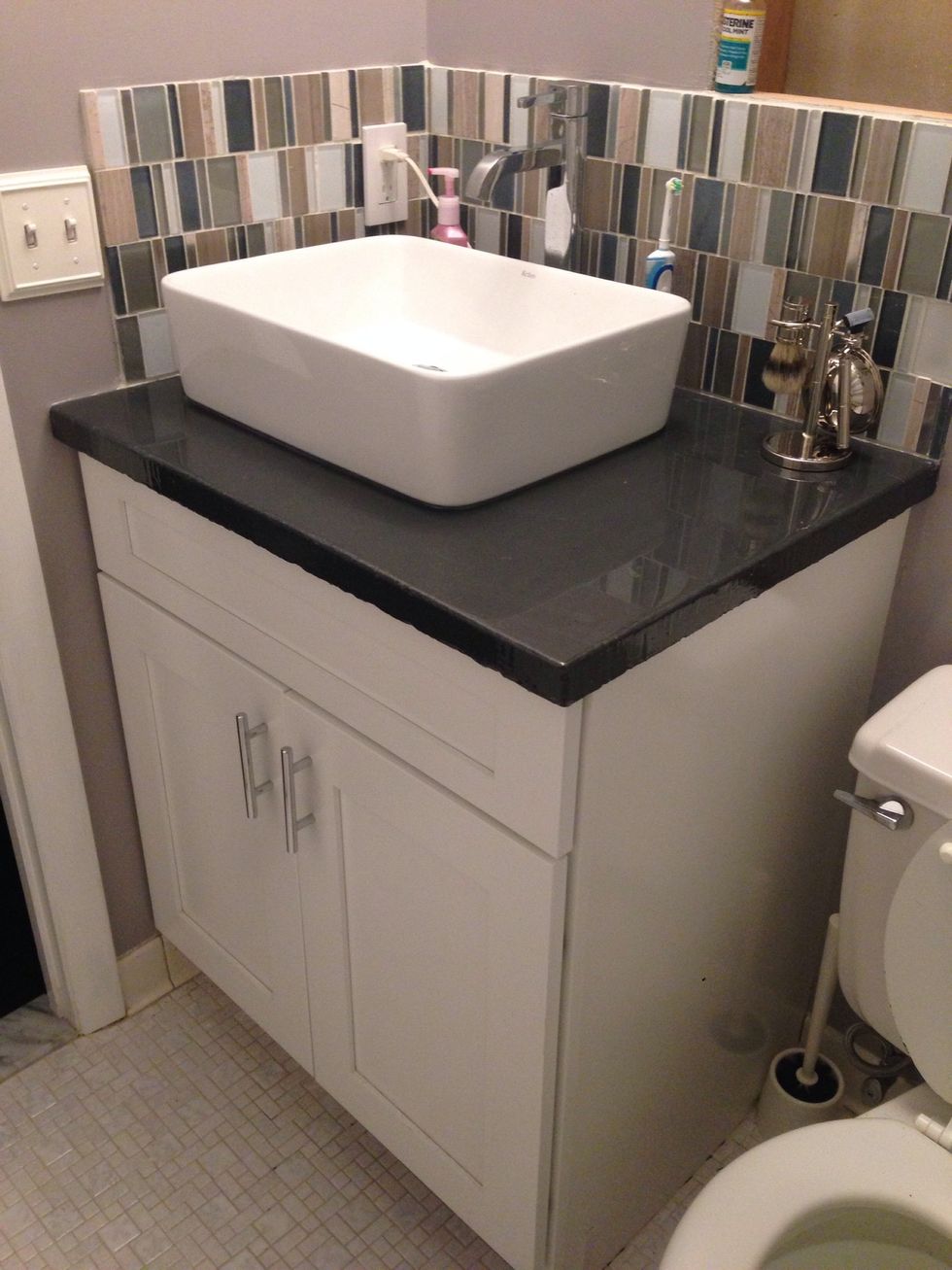 We used an adhesive the seal the edges before we added our backsplash tile. Then the sink!