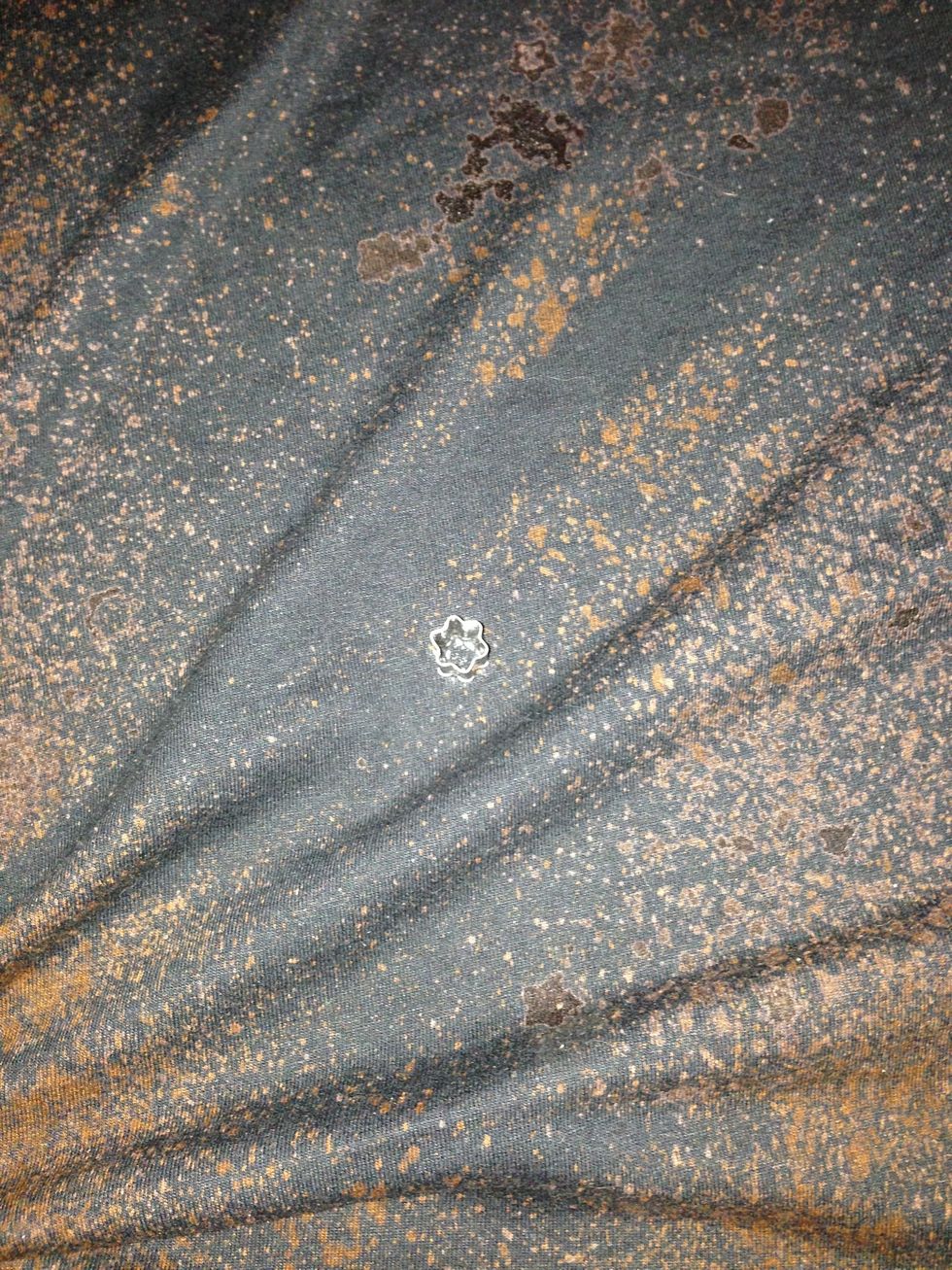 We used mini star cookie cutters to make stars. We used 2 techniques. First,  we set them on the shirt and sprayed them. Then, we dipped them on bleach and stamped them.