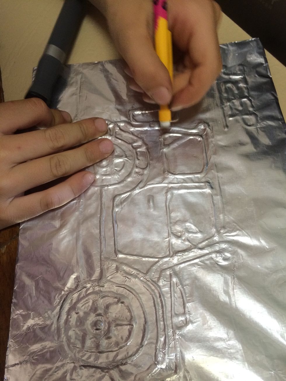 We used our fingers and a rubber on the end of a pencil to press down and stretch the foil