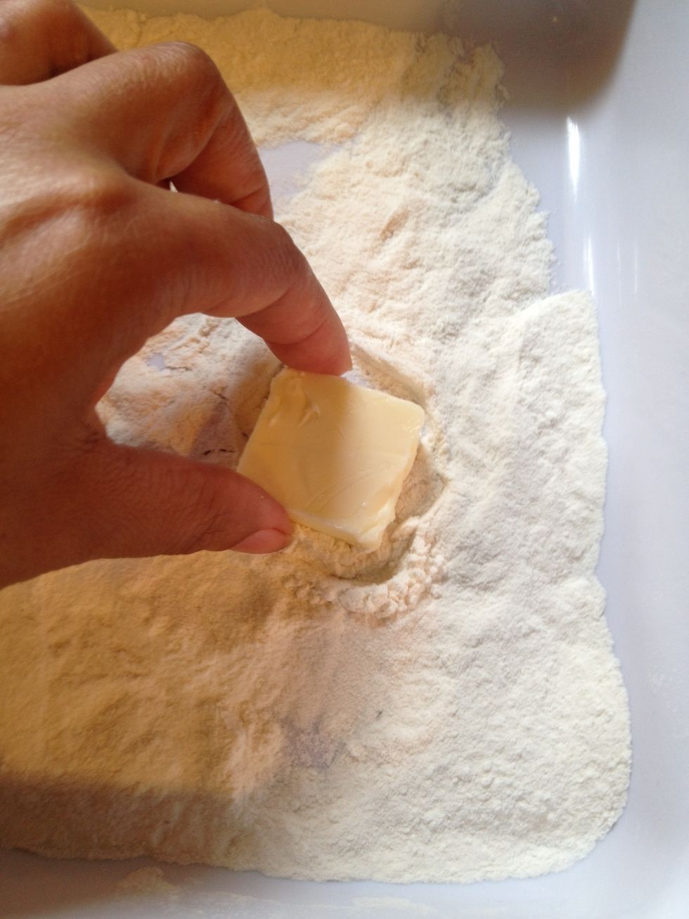 We will now take the remaining 2 tablespoons and press it in some flour. Be generous  please