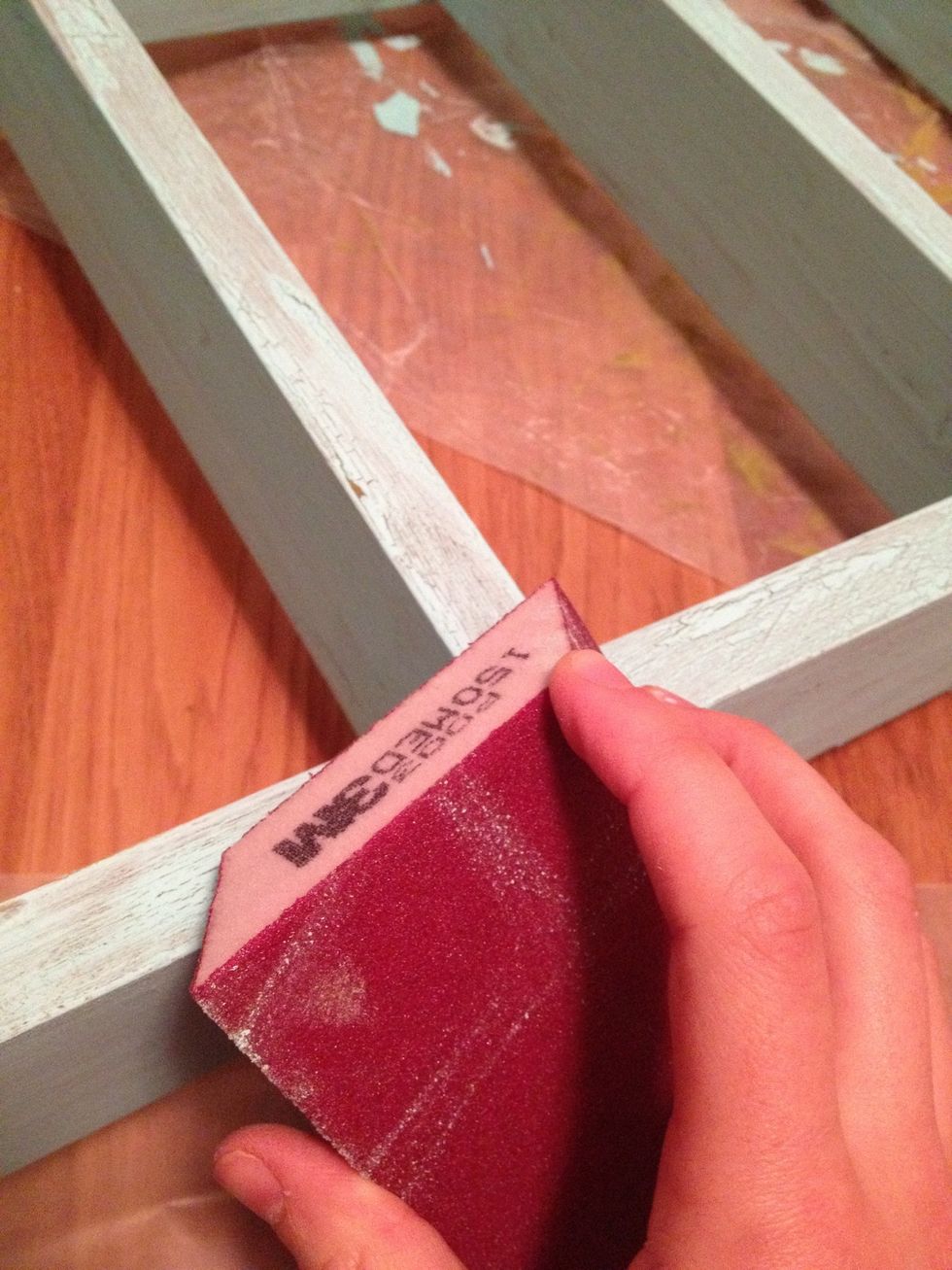 Wear a mask. Sand down edges and corners that would naturally wear. This takes some patience, not brute force. If you push hard you will sand through your base coat, which may look nice in some spots.