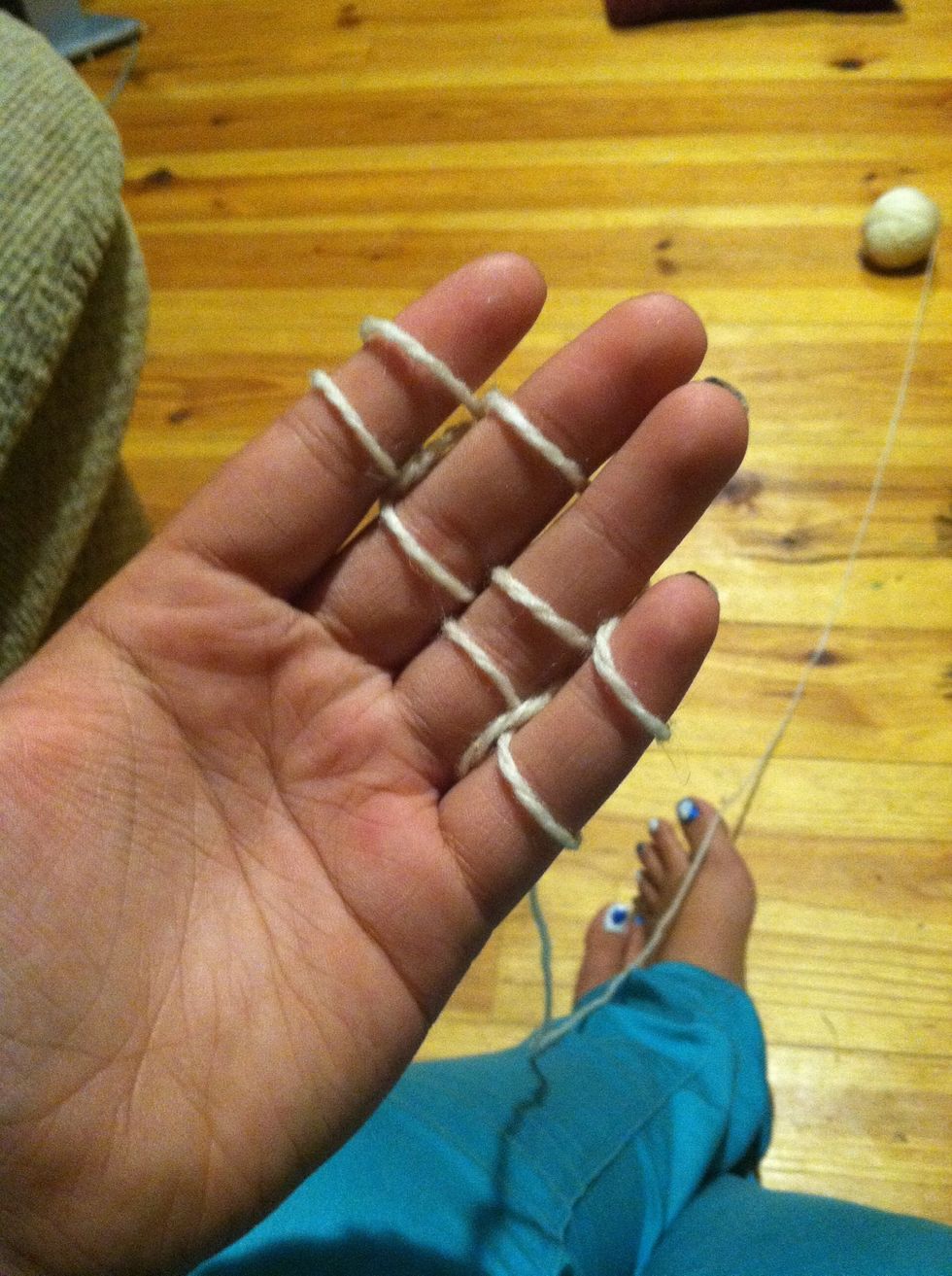 Weave another 2 rows above the remainders on the bottom, and repeat the process of looping it over your fingers.