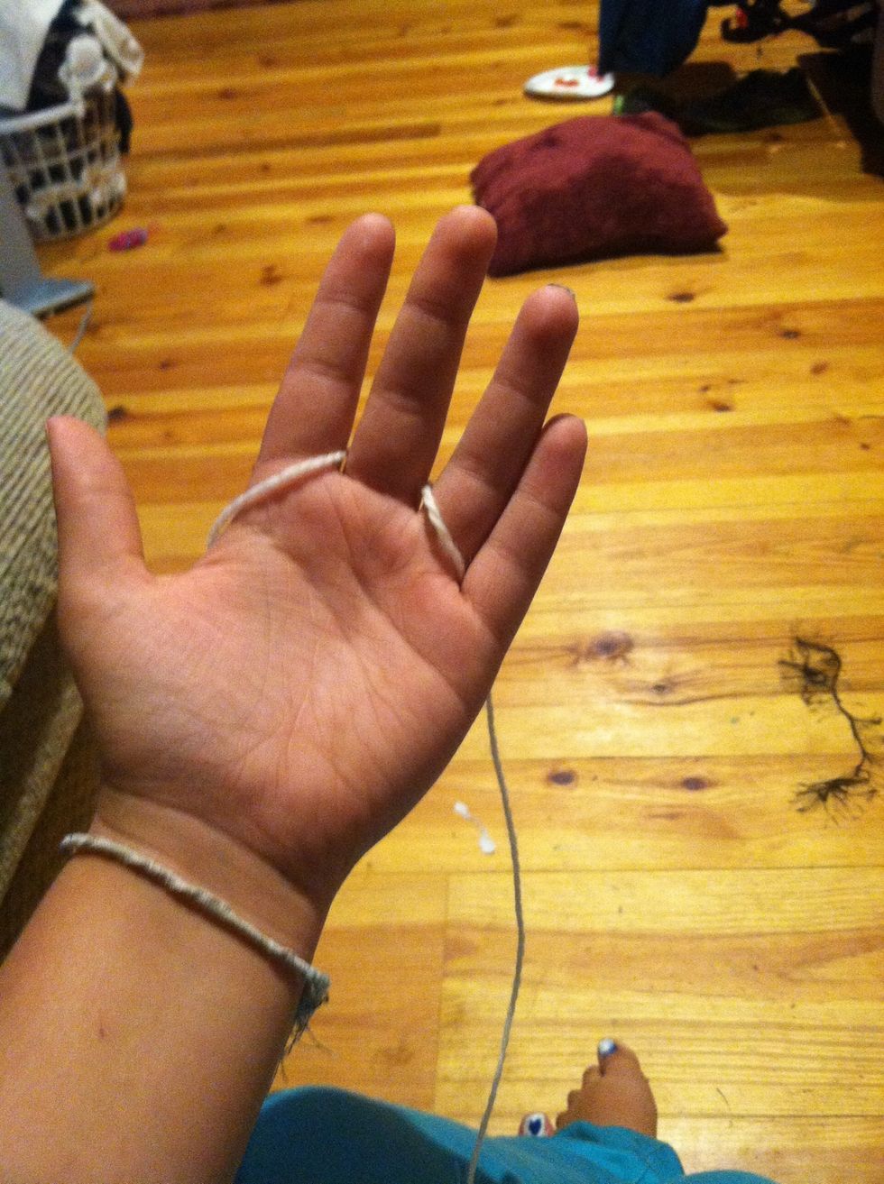 Weave the remainder of the string between the rest if your fingers.