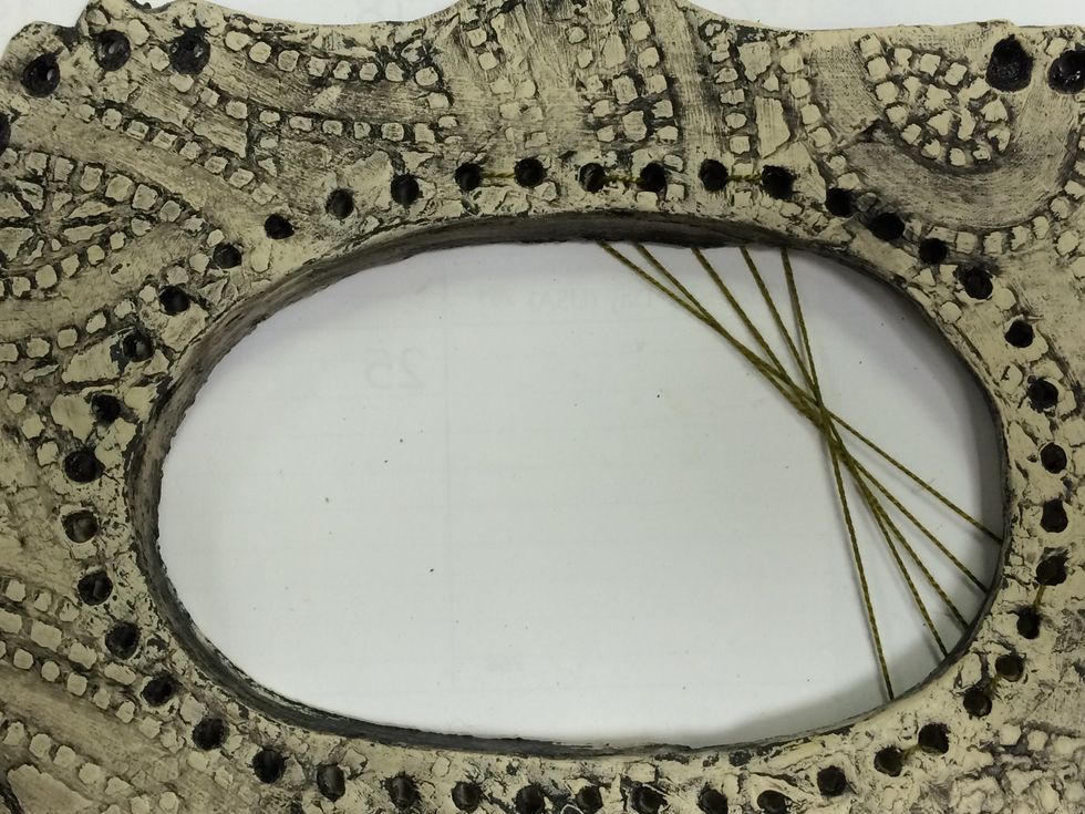 Weave the thread back and forth to create the line design. Notice how my thread is all on the back of the loom.