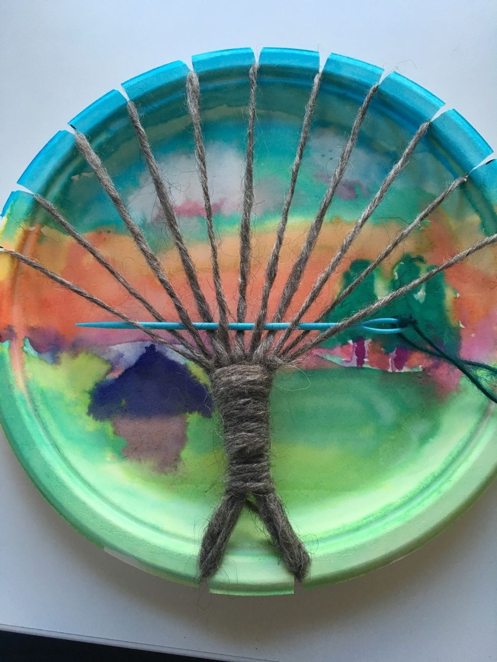 Weave your needle over and under the branches.