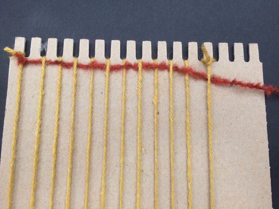 Weave your yarn. Go over the first row under the second and follow that pattern. Over under over under....