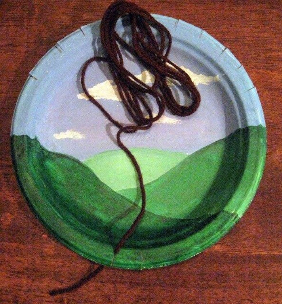 Wedge the end of your yarn into the bottom left hand notch.