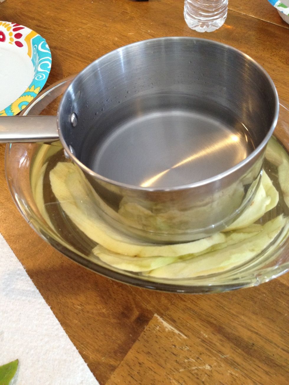 Weigh down a pan with water to submerge eggplant