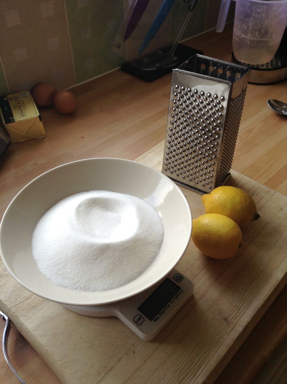 Weigh out the sugar and grate the lemon zest into it, then rub the two together in the bowl
