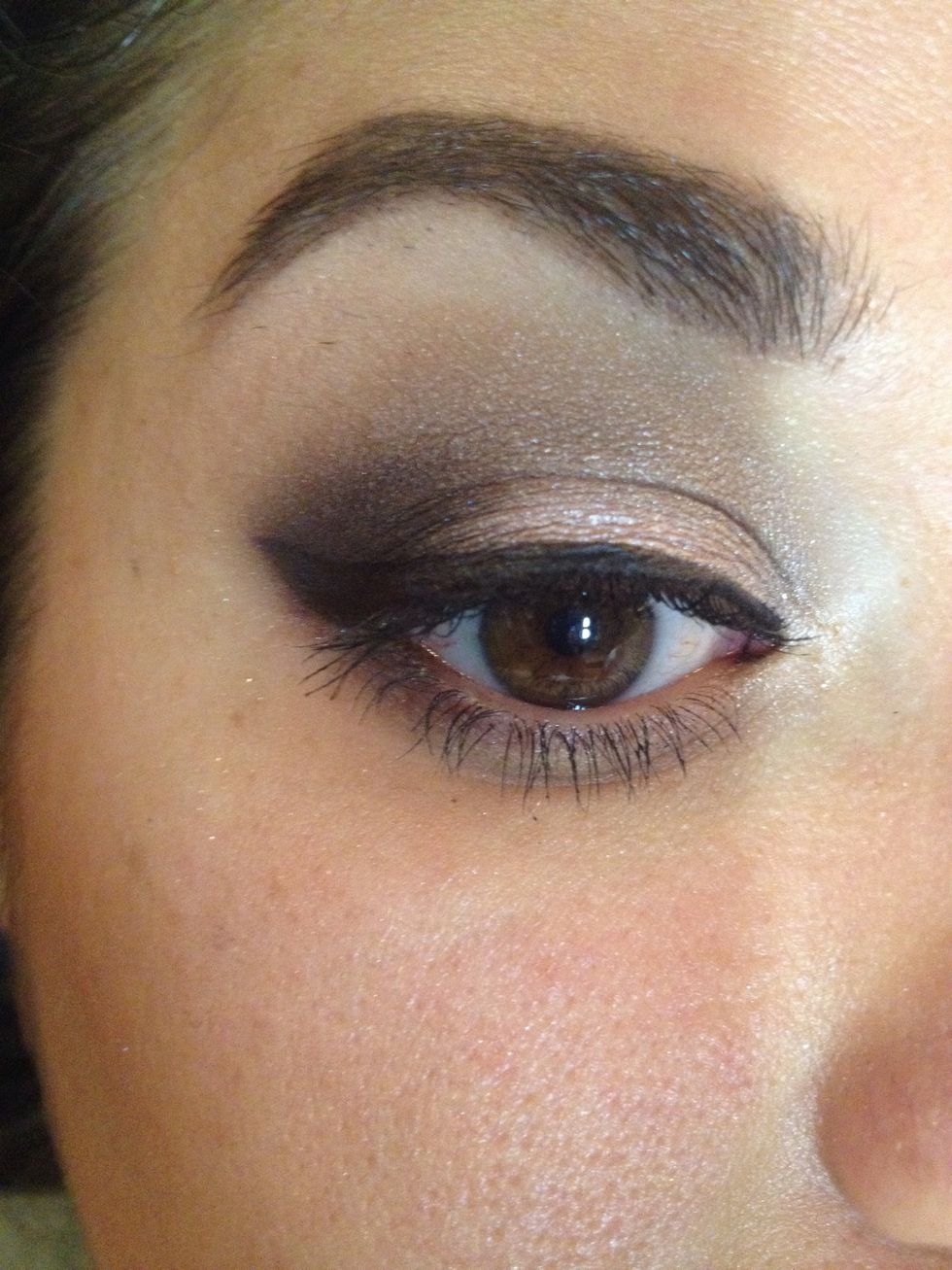 Wet a liner brush and apply black shadow as liner across your top lash line