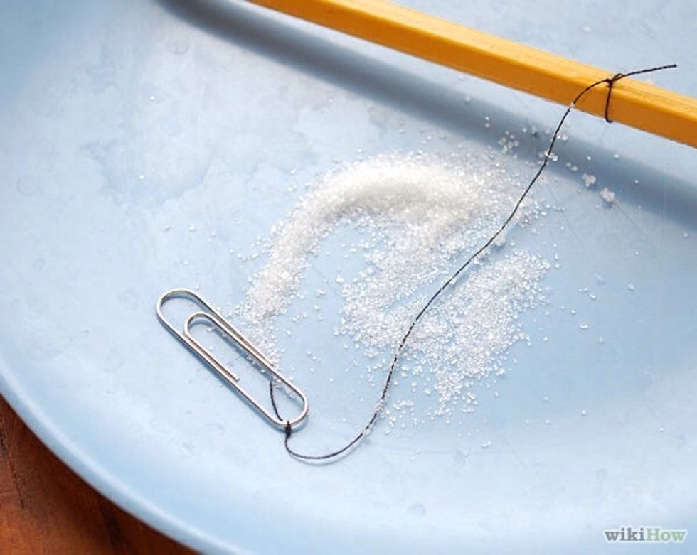 Wet the string with a water and roll it in the sugar.