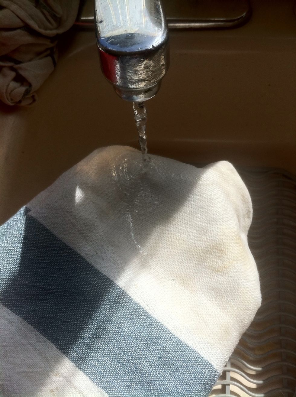 Wet the washcloth completely