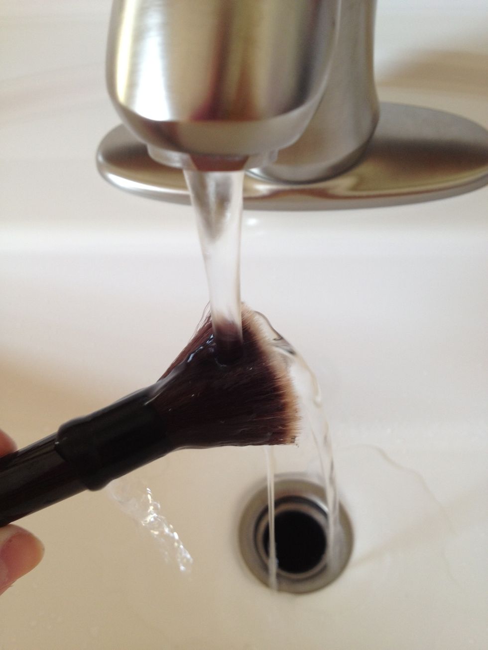 Wet your brush under some water. Doesn't matter what temperature.
