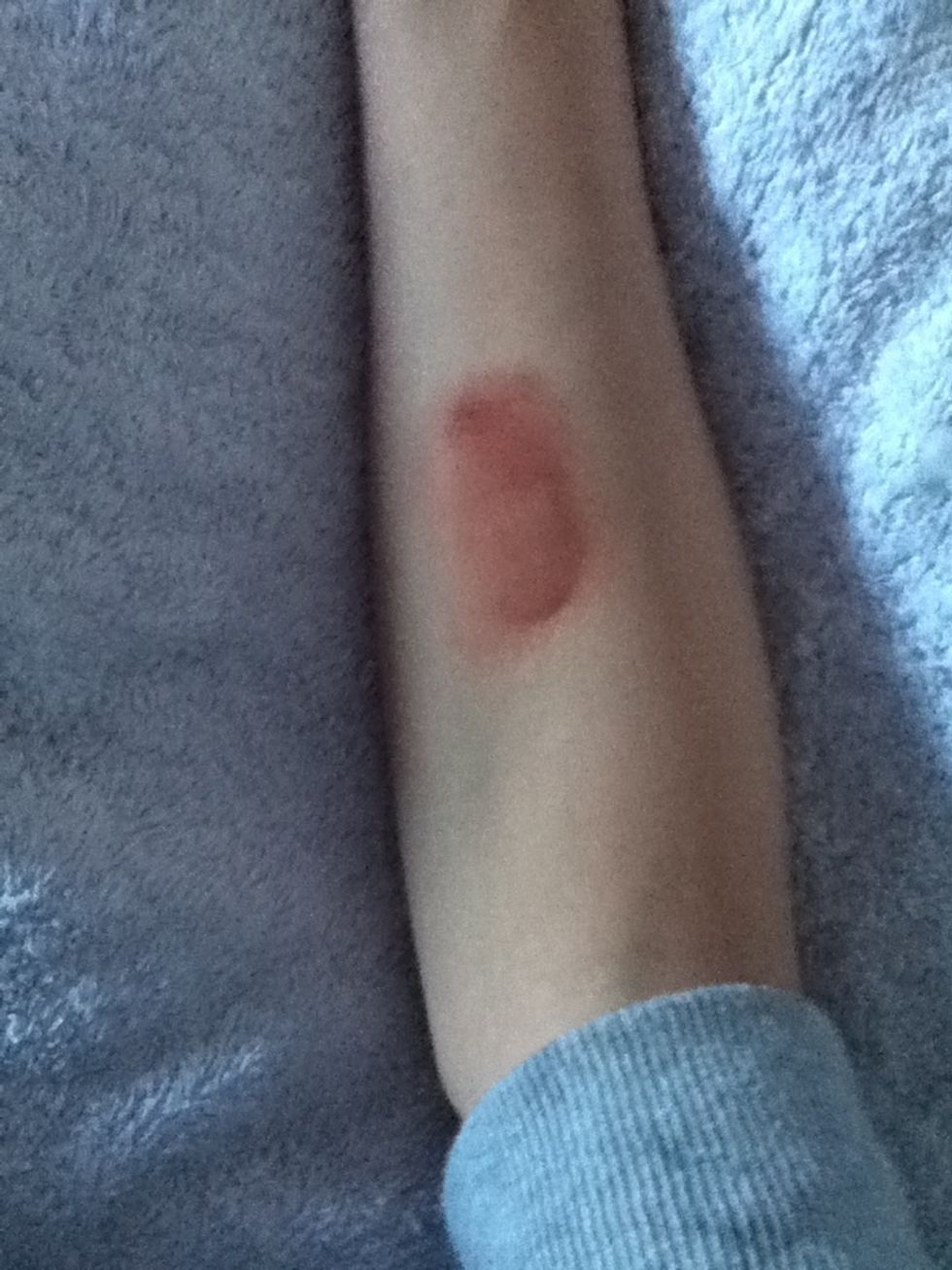 Wet your finger (using water or lick it) and smudge the red so there is no definite shape, make some areas not as smudged for a better effect :)