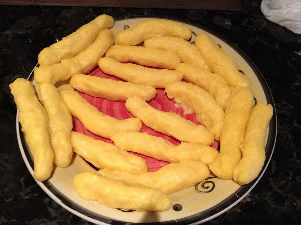 Wet your hands with warm water, and grab enough to form in the shape of sticks.... Not to thick not to thin.