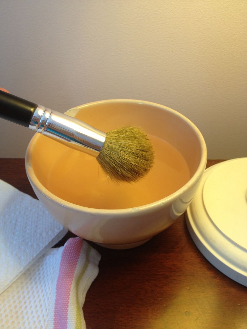 Wet your makeup brushes in a bowl of warm water.