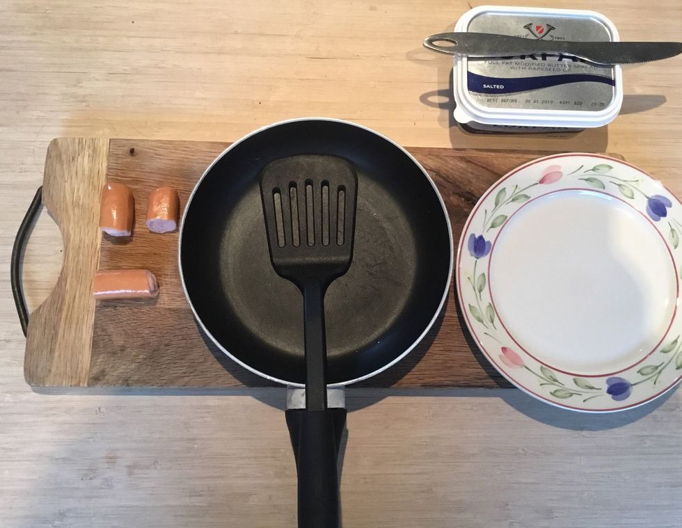 What you need: A knife, Butter, A pan, A plate, Sausages and a board