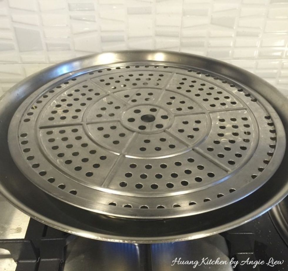 When about to steam the muffins, prepare the steamer by boiling some water in a wok.