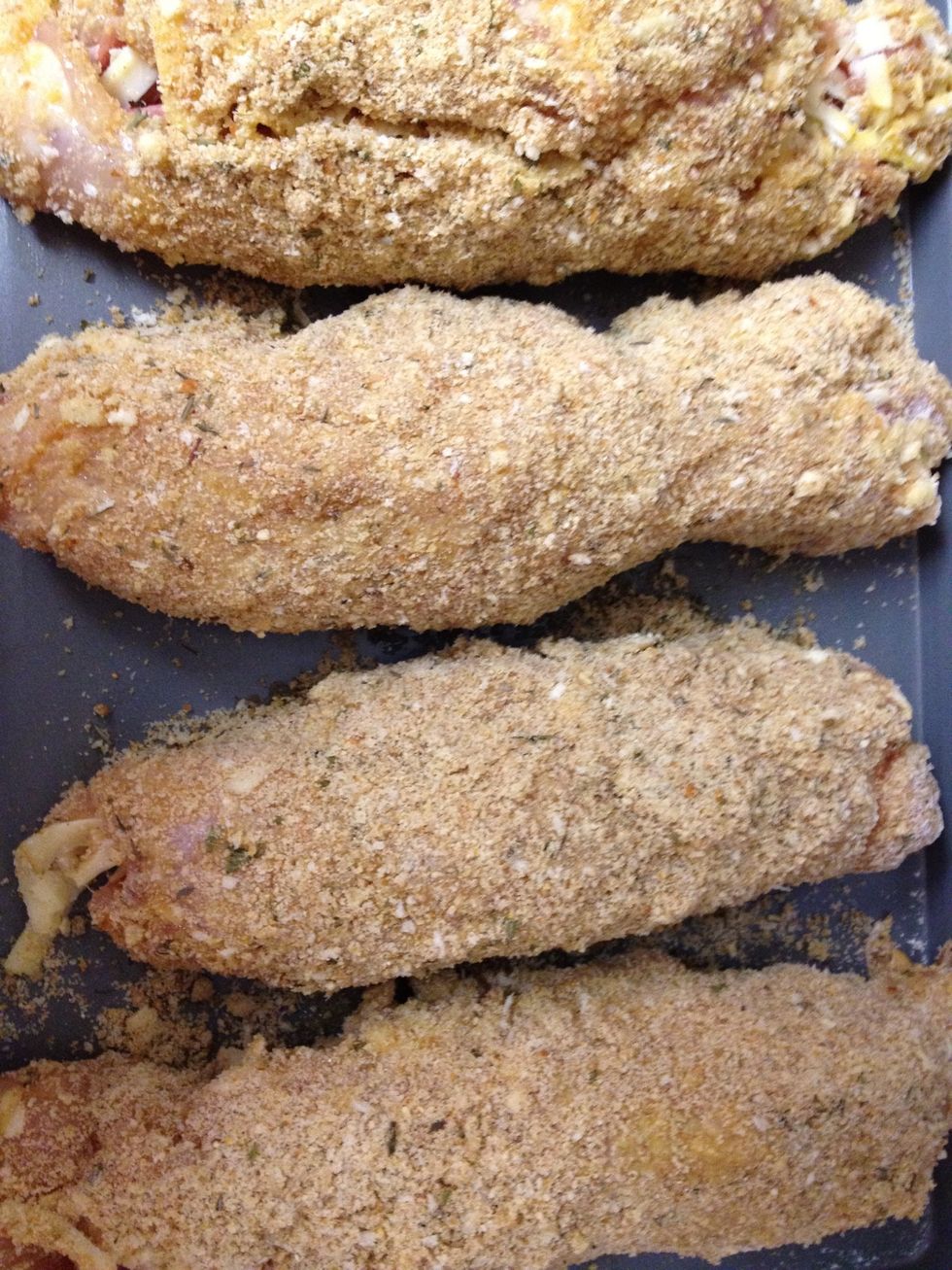 when all of the chicken breasts are filled, rolled, and breaded we put them in the oven for 20-30 minutes, or until chicken is cooked fully.
