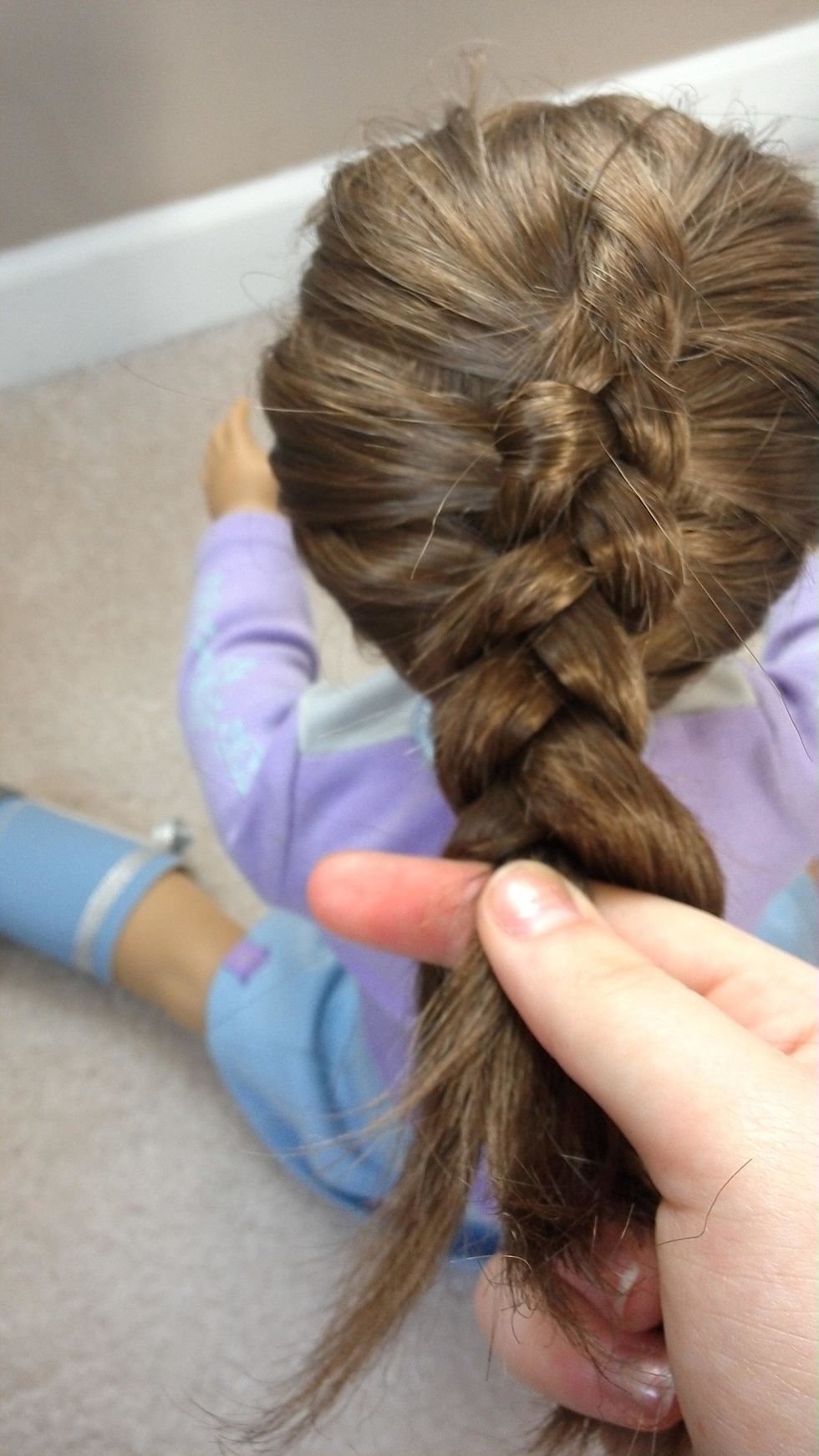 When all of the hair is added begin to traditional braid the rest of the hair until you reach the ends.