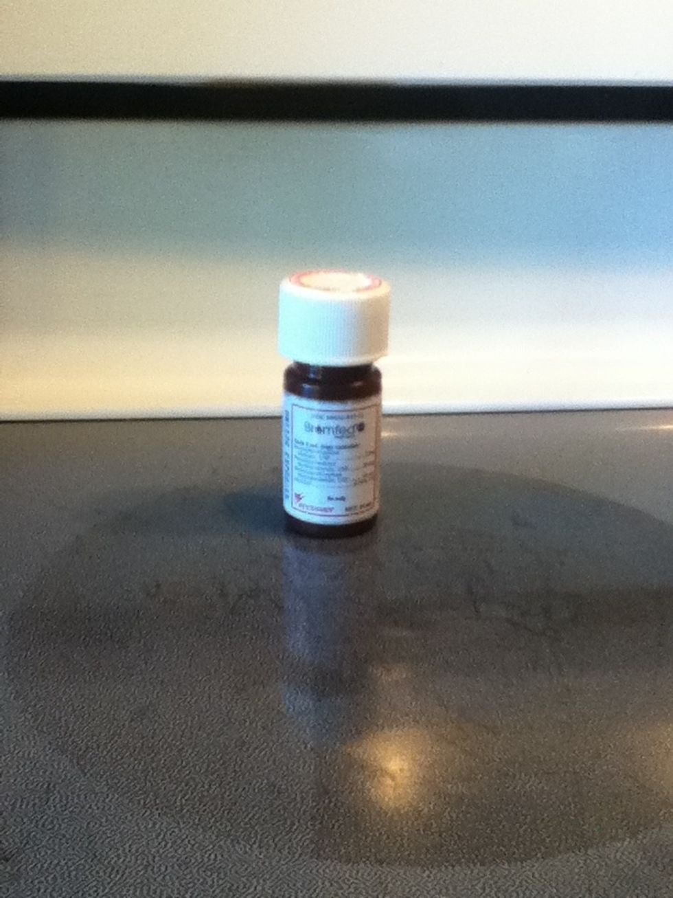 When all of the ingredients are melted, pour it into a container. I am using this empty medicine bottle but anything works.