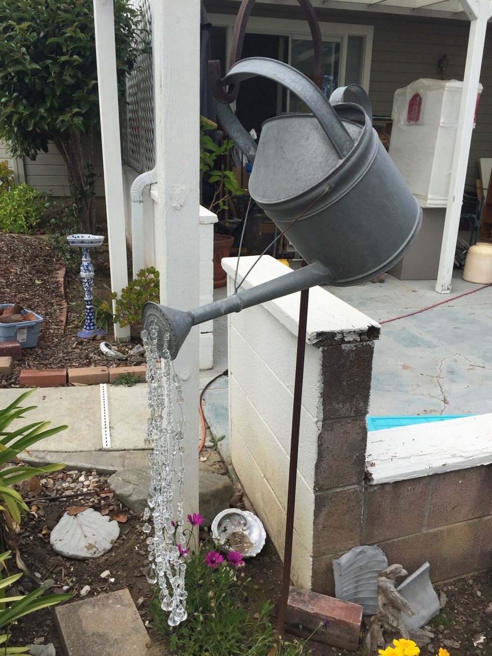 When all of your strands are complete, put spout back on watering can and hang in the garden. I think I made seven strands for this project.