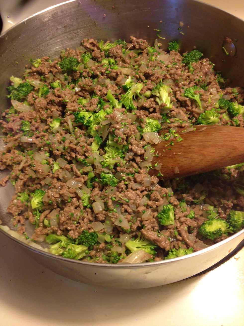 When beef is done, strain off any excess juices that may have accumulated and add broccoli. Turn off the heat, cover the skillet for a few minutes to allow the steam to somewhat cook the broccoli.