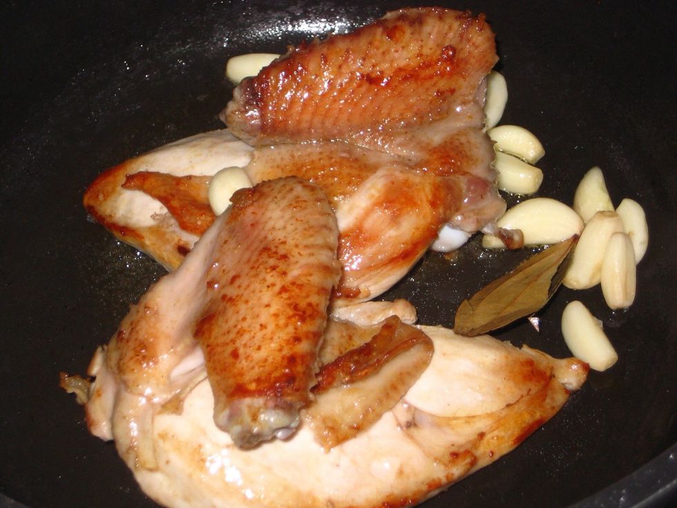When browned, add the garlic and bay leaf