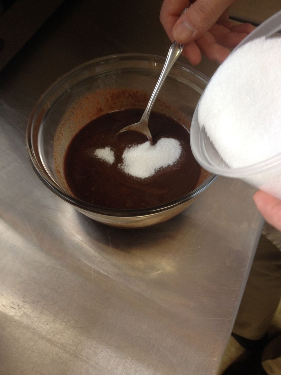 When chocolate and butter has been melted smooth, gradually add in the sugar