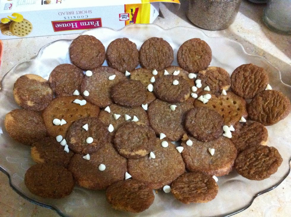 When coffee is done, Keep it hot/warm so cookies can soak it up easily. Layer up ur 1st cookie layer n sprinkle white choc chips. I got coconut cookies here. U can take any u like. Refrigerate ur dish
