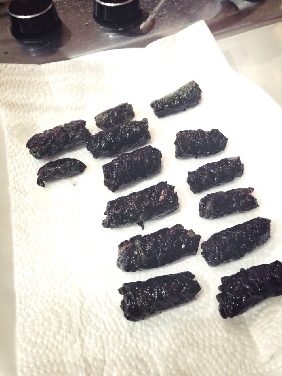 When cooked it should be dark green or slightly black (not too black or it's burnt!). I usually place them on a towel to soak excess oil