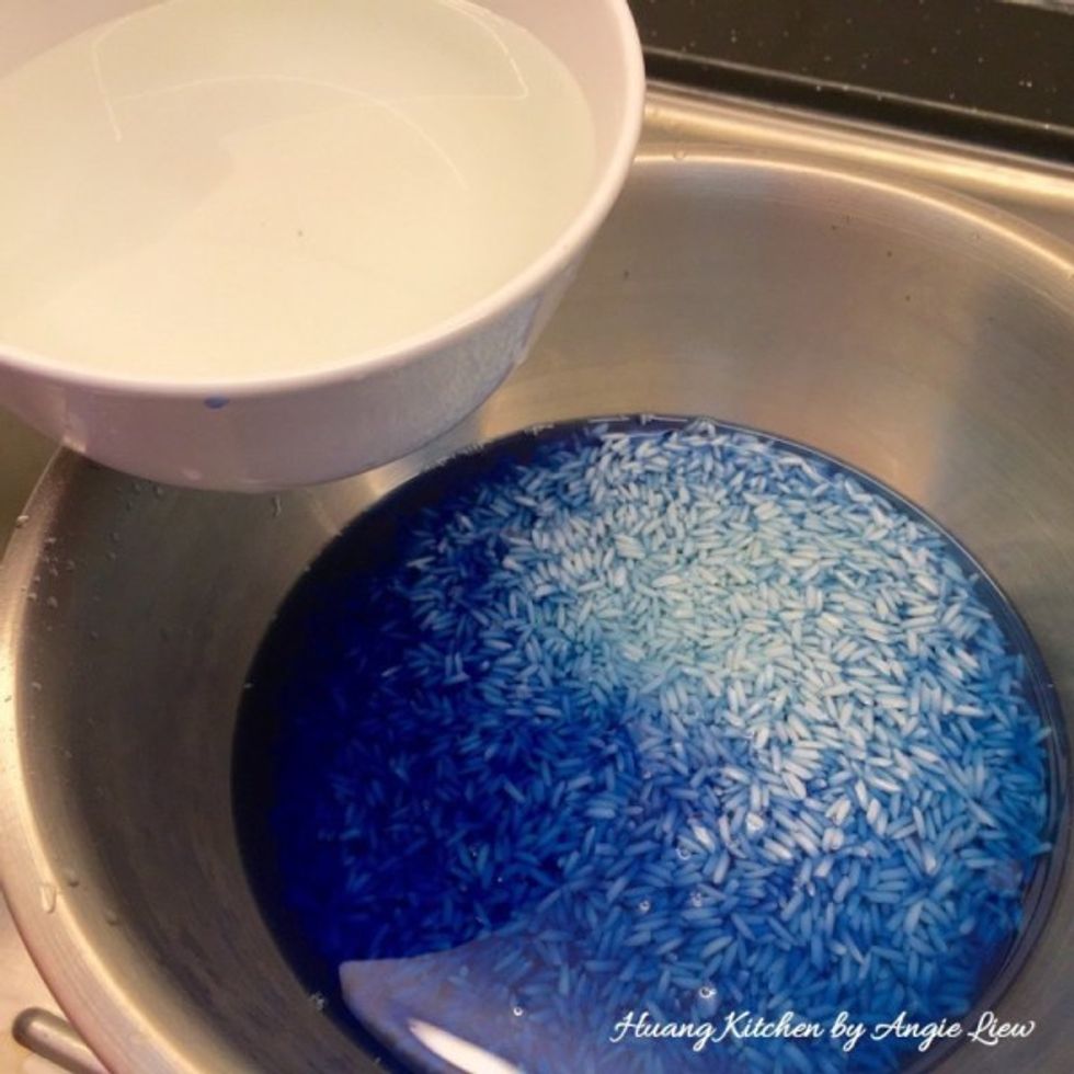 When cooled, add the blue coloured water into the smaller portion of the rice. Add more water to ensure the rice is fully submerged. Leave to soak overnight.