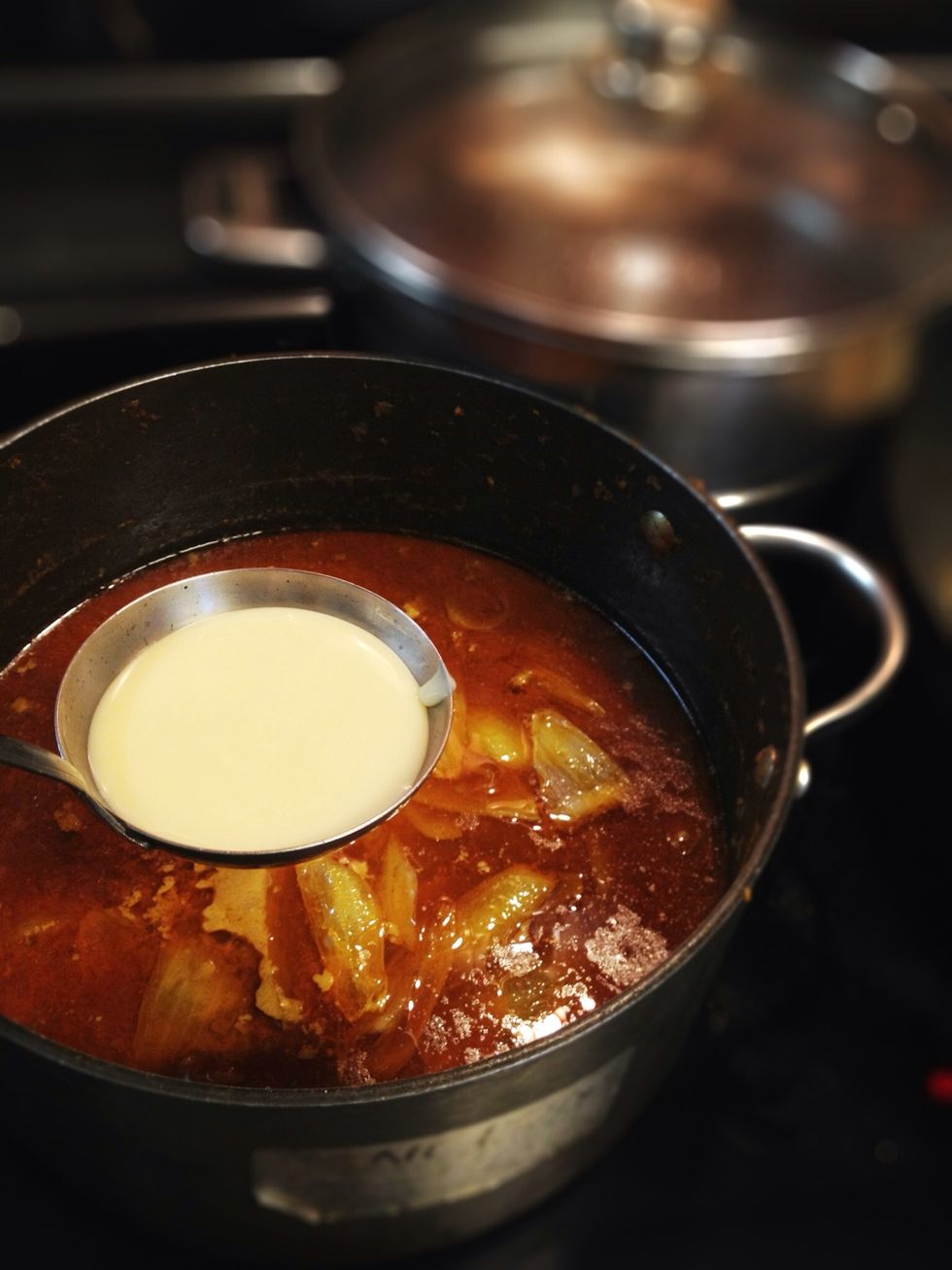 When curry is boiling, add about 3 tbsp condensed milk & a can of coconut milk.